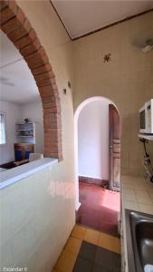 a kitchen with an archway in a kitchen with a sink at Suites Santo Domingo in San Miguel de Allende +215 photos