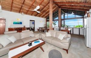 a living room with a couch and a table at Boonooloo on Absolute Beachfront in Newell Beach