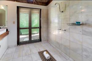 a bathroom with a shower and a sink at Boonooloo on Absolute Beachfront in Newell Beach +6 photos