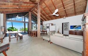 a living room with a white couch and a table at Boonooloo on Absolute Beachfront in Newell Beach