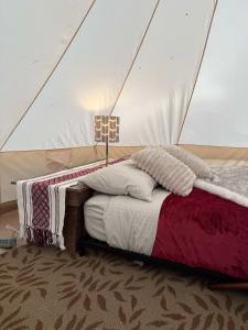 a bedroom with a bed in a tent at Willowbank Bell Tent in Golden