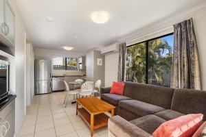 a living room with a couch and a table at Brisbane Gateway Resort in Rochedale