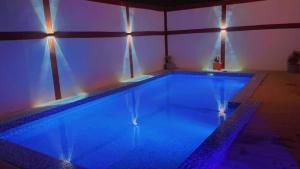 a large swimming pool with lights in a building at Résidence keur Saloum in Thiès