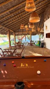 a pool table with balls on top of it in a room at Bossa Atins in Atins