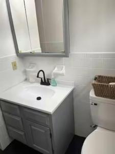 a white bathroom with a sink and a toilet at Rustic Mountain view Cabin 5 mins to Ski Area! in Windham +46 photos