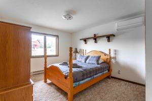a bedroom with a bed and a window at Rustic Mountain view Cabin 5 mins to Ski Area! in Windham