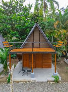 a small house with a bench and a table at Sloth Bungalows Manzanillo in Manzanillo
