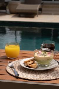 a table with a bowl of food and a glass of orange juice at The Providence Hotel Boutique - Adults Only in San Andrés +91 photos