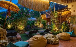 a restaurant with a bunch of chairs and plants at GWK View Boutique Hotel and Serviced Residence in Jimbaran