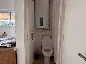a small bathroom with a toilet with the lid up at L Effet Mer Cocon climatisé avec terrasse et jardin privés Piscine in Audenge +9 photos
