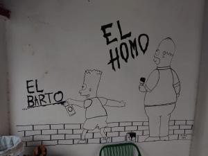 a drawing of two men on a wall at Hostel Chaton in Asunción