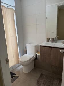 ein Badezimmer mit weißer Toilette und Waschbecken in der Unterkunft Epic Hotel Temuco in Temuco + 20 Fotos