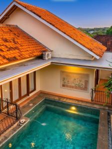 a house with a swimming pool in front of it at GWK View Boutique Hotel and Serviced Residence in Jimbaran