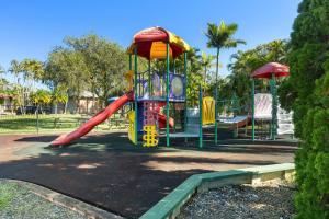 a playground with a slide in a park at Brisbane Gateway Resort in Rochedale