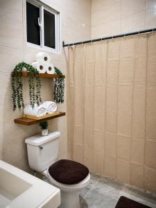 a bathroom with a toilet and a sink and a shower at Alojamiento en Miches in Miches