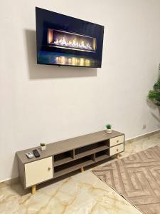 a living room with a fireplace on the wall at Alojamiento en Miches in Miches