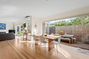 a living room with a wooden table and chairs at Kassandra in Point Lonsdale