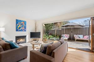 a living room with two couches and a fireplace at Kassandra in Point Lonsdale