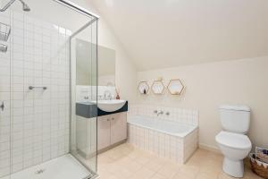 a bathroom with a shower and a toilet and a sink at Kassandra in Point Lonsdale +14 photos