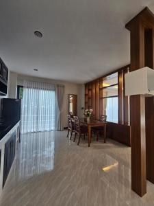 a kitchen and dining room with a table and chairs at Anda Sea view in Klong Muang Beach