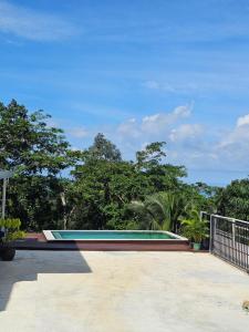 a swimming pool with trees in the background at Anda Sea view in Klong Muang Beach