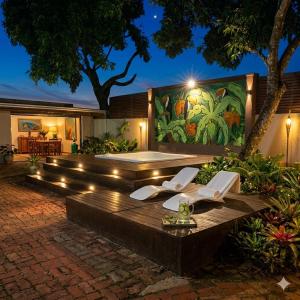 a patio with a wooden table with lights on it at La Locanda Art & Taste Retreat in Puerto Iguazú