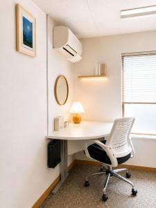 an office with a white desk and a chair at Lee Ryokan Tokyo in Tokyo