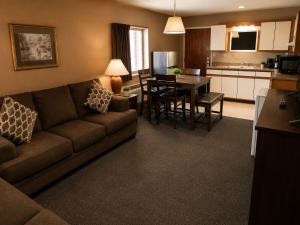 a living room with a couch and a table and a kitchen at Alleghany Inn Blue Ridge in Sparta