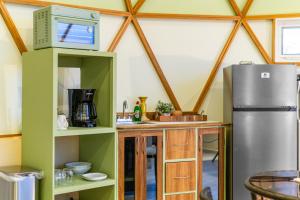 a kitchen with a refrigerator and a counter in a room at Los Domecitos - Geodesic Dome Retreat in Los Barriles +33 photos