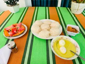 a table with plates of food on a table at Airport Kiyas Transit Villa Free Airport Pickup or Drop in Katunayaka +17 photos