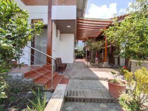 an external view of a house with a courtyard at Hosteria Chyrywasy Home in Ibarra