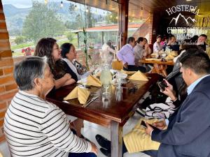 a group of people sitting at a table in a restaurant at Hosteria Chyrywasy Home in Ibarra +26 photos