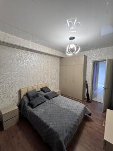 a bedroom with a large bed and a ceiling at Nadikvari in Tbilisi City