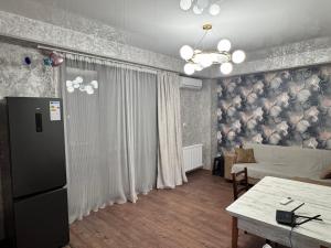 a living room with a couch and a table at Nadikvari in Tbilisi City