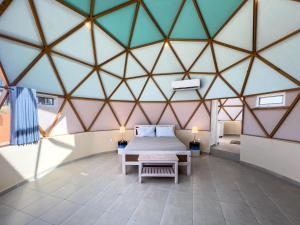 a bedroom with a bed in a triangular ceiling at Los Domecitos - Geodesic Dome Retreat in Los Barriles