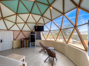 a room with a table and chairs in a tent at Los Domecitos - Geodesic Dome Retreat in Los Barriles