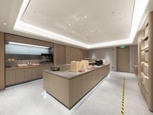 a large kitchen with a counter in a room at JI Hotel Beijing Panjiayuan in Beijing +54 photos