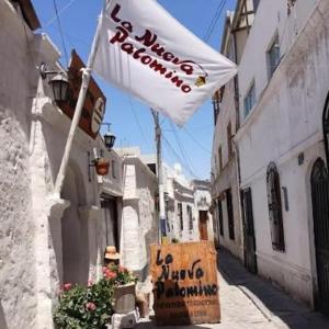 a white flag on a street with a flag at Hospedaje Totocha Yanahuara Arequipa in Yanahuara +2 photos
