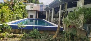 a swimming pool in front of a house at Ali's Homestay in Pacific Harbour +4 photos
