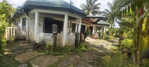 a small house with a porch and a pathway at Ali's Homestay in Pacific Harbour