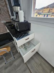a white drawer with a microwave on top of it at Elegant Studio - Ideal for Couples in Mazagran