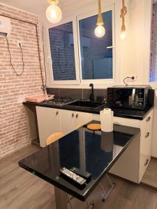 a kitchen with a counter with a sink and a microwave at Elegant Studio - Ideal for Couples in Mazagran