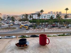 a view of a city from a balcony with cups at Bab bhar sousse in Sousse