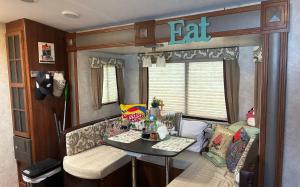 a living room with a table in an rv at My Little RV Getaway in Pass Christian +21 photos