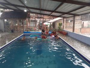 a group of people in a swimming pool at Hosteria Chyrywasy Home in Ibarra