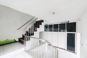 an image of a staircase in a house at Hotel Idayu Natuna Palembang RedPartner in Palembang