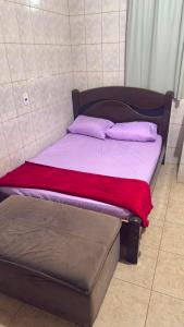 a bed with two pillows on top of it at Pousada Dois Irmão in Uberaba