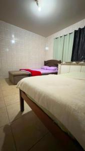 a bedroom with two beds in a room at Pousada Dois Irmão in Uberaba
