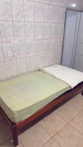 a small bed in a room with at Pousada Dois Irmão in Uberaba +1 photo