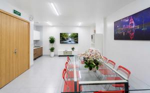 a hospital room with a glass table and red chairs at Phu Hai Apartment in Dong Hoi